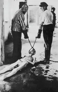 Extinction: Concentration camp internees dragging the body of a victim