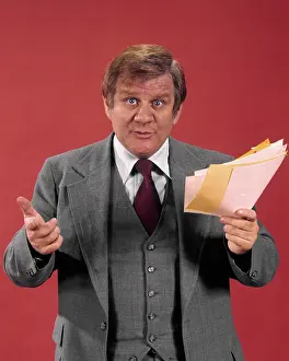 Sincere: Concerned Businessman Holding Papers Gesturing and