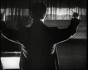 Raises: Conductor and Orchestra Performing As the Curtain Raises