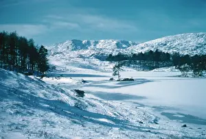 Tarn: Coniston Old Man over the ice of Tarn Hows