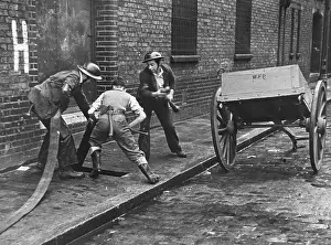 Cobbles: Connecting up a hosepipe during the Blitz