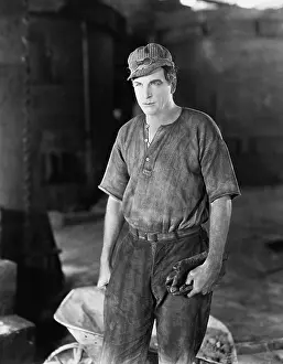 Thirtysomething: Construction worker standing near a wheelbarrow