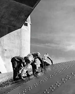 Barrier: Construction workers applying a coat of paint