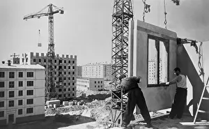 Fabricated: Construction workers building an eighty unit apartment