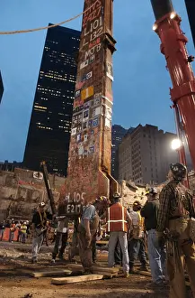Mementos: Construction workers maneuver the last piece of
