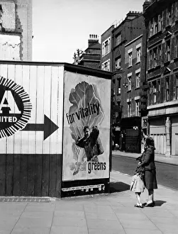 Nutritional: Contemplating a nutritional advice poster in London, 1940s