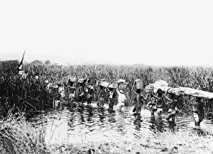 Burdens: Convoy of carriers crossing a river, 1908