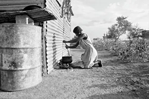 Deemed: Cooking outside her newly erected home after being