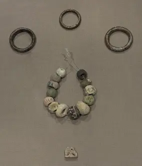Amulet: Copper hair-rings and ring, beads and an amulet
