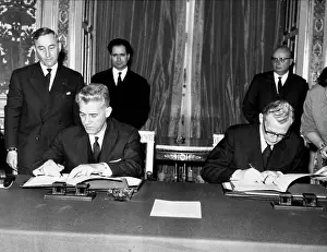 Cornelio: Corneliu Manescu signing papers at a meeting
