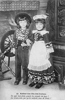 Bumpkin: Two country bumpkins posing next to a spinning wheel