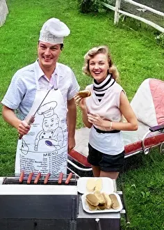 Snacks: Couple Backyard Grilling Looking at Camera Cooking