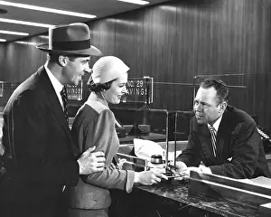 Transaction: Couple At Bank Window