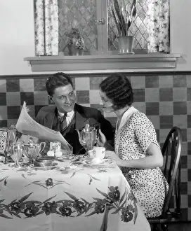 Newsprint: Couple at breakfast table looking over newspaper