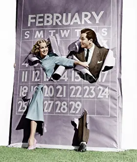 Calendars: Couple bursting through leap year calendar