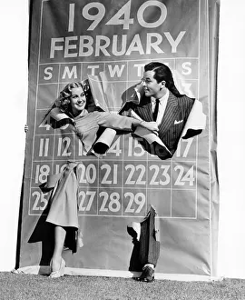 Calendars: Couple bursting through leap year calendar