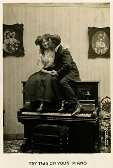 Cuddling: Couple canoodling on a piano