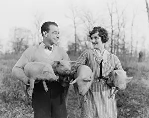 Companionship: Couple carrying pigs