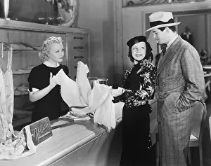 Purchasing: Couple and clerk in shop