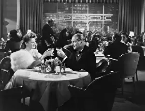 Upscale: Couple dining in crowded restaurant