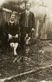 Untidy: Couple with a dog in a garden