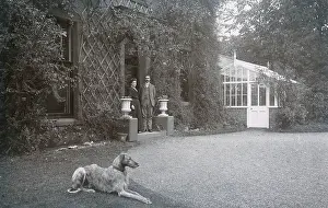 Driveway: Couple in doorway with a dog