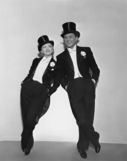Supportive: Couple in top hats leaning on each other