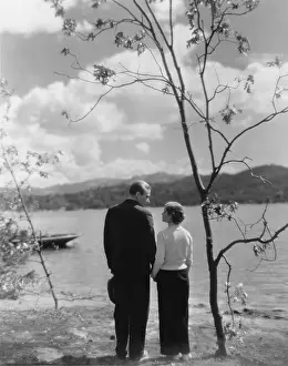 Vistas: Couple holding hands beside a lake