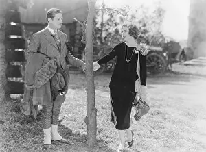 Heterosexual: Couple holding hands by tree