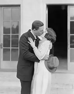 Fedora: Couple kissing outside