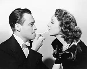 Boyfriends: Couple lighting two cigarettes at once with a cigarette