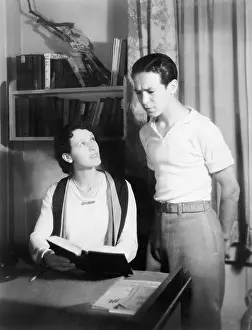 Worrisome: Couple looking at a book and looking worried