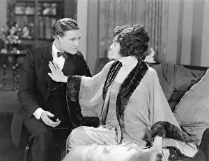 Confronting: Couple looking at each other while she is pushing him away