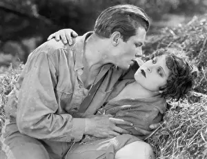 Intimacies: Couple lying together in hay