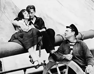 Interactions: Couple and man steering sailboat