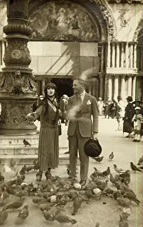 Pigeons: Couple with pigeons in St Mark's Square, Venice