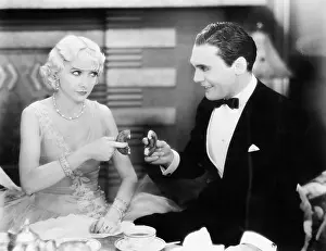 Romancing: Couple playing a game of sharing a doughnut