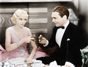 Flirtatious: Couple playing a game of sharing a doughnut