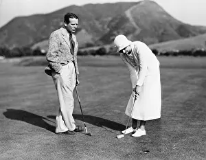 Noticing: Couple playing golf together