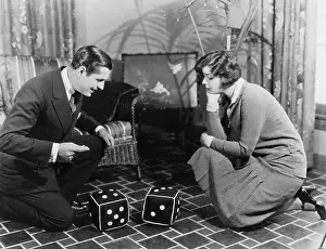 Gamblers: Couple playing with huge dice