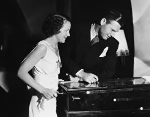 Diversion: Couple playing with pinball machine