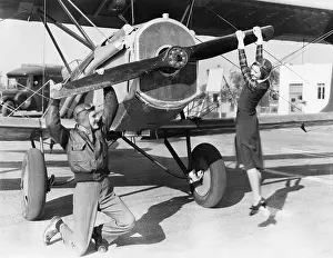 Levers: Couple playing with propeller on plane