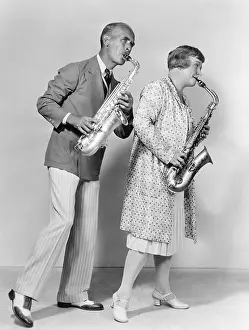 Coordinate: Couple playing saxophones together