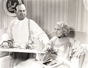 Displeased: Couple quarreling over breakfast in bed