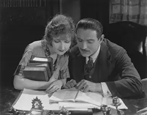 Soulmates: Couple reading book at desk