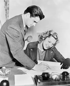 Businesspeople: Couple reading a document together