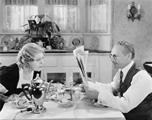 Eyesight: Couple reading newspaper at breakfast table
