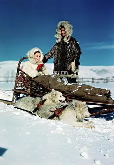 Parkas: Couple Riding Dog Sled in Winter