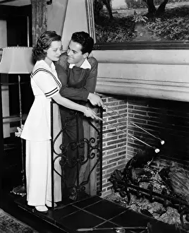 Snacks: Couple roasting marshmallows over fireplace