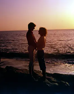 Gleam: Couple by the sea in the sunset, Cornwall
